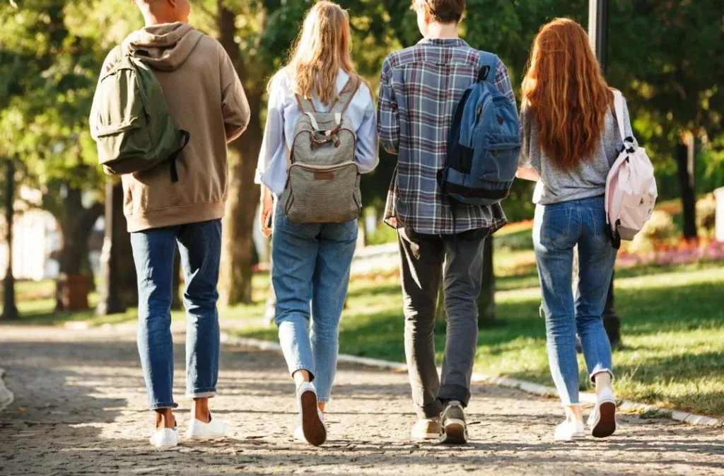 Young people with backpacks walking outdoors — trips, travel and school life beyond the walls — school liability RMA Tangier